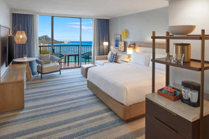 Large Bed, Sofa and Sitting Area in a Guest Room with Balcony and Water View-transition.jpg